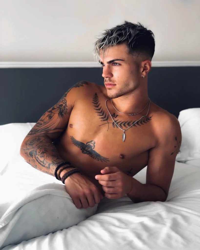 10. Winged Figure and Laurel Chest Tattoo