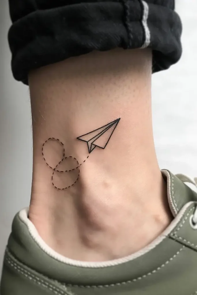 16. Minimalist Paper Airplane Ankle Tattoo
