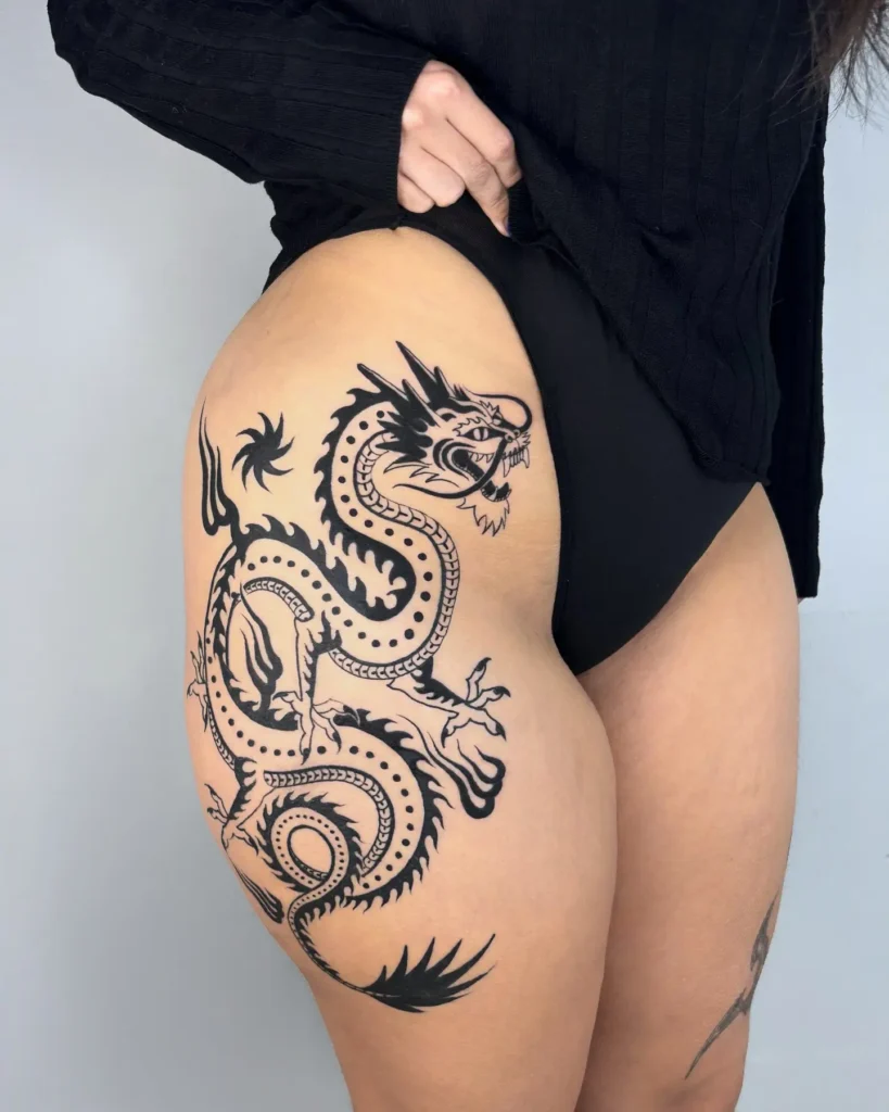 20. Fierce Blackwork Dragon Thigh Tattoo