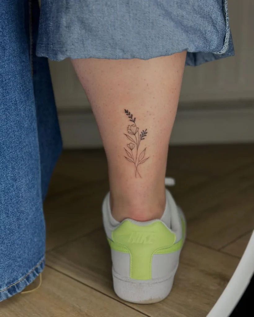8. Petite Wildflower Ankle Tattoo