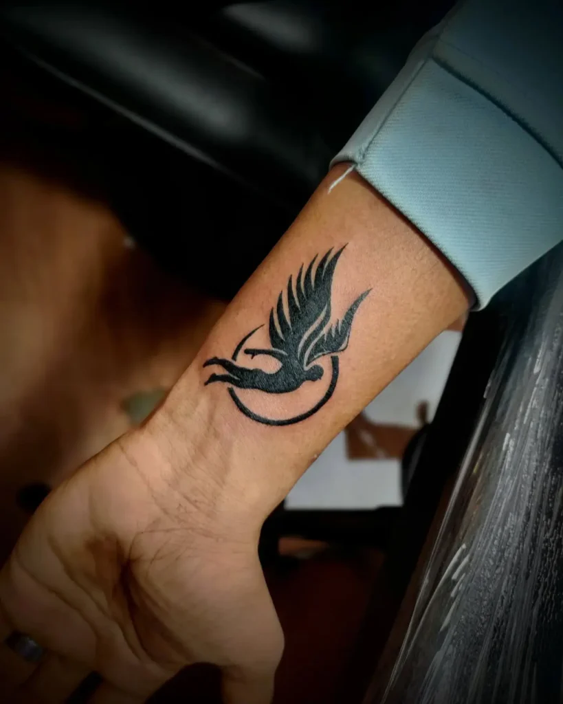 9. Bold Soaring Bird Wrist Tattoo