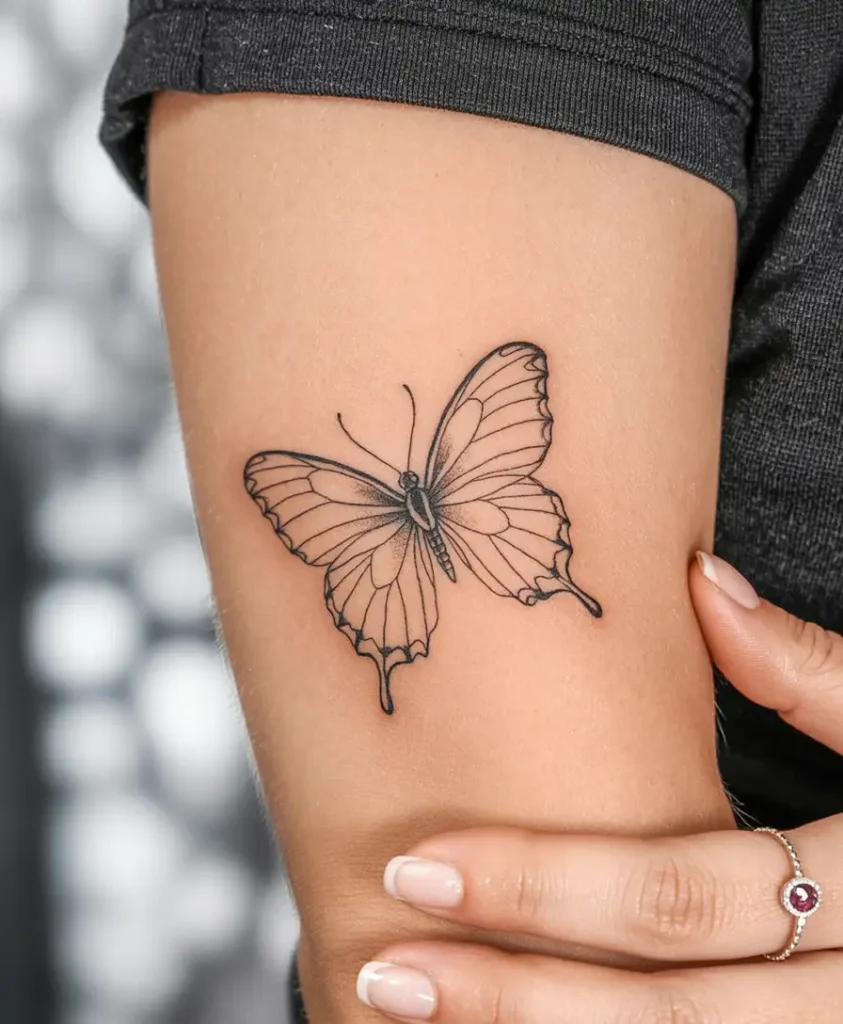 Single Line Butterfly on a female shoulder