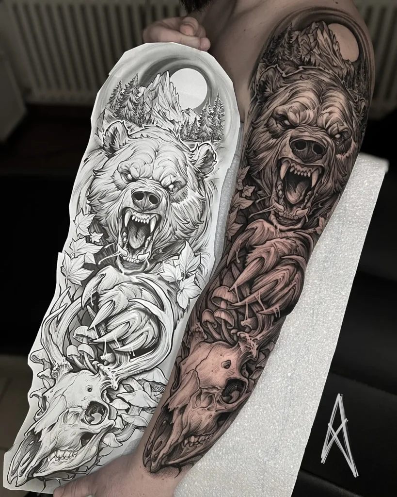 Hyper-realistic bear sleeve tattoo covering the full arm, featuring a roaring grizzly head with fangs, forest trees, mountain peaks, and a detailed deer skull below. Rich black and grey shading creates depth and texture, while dramatic elements reflect wilderness and primal strength. Design shown beside matching stencil sketch.








