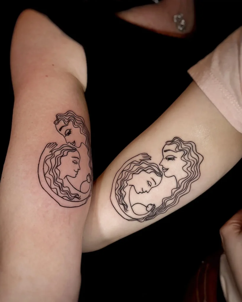 Two forearms with matching minimalist tattoos, each showing a mother and daughter’s faces outlined in black ink and enclosed within each other’s arms. The circular line art creates a sense of unity and protection. This design stands out among mom and daughter tattoos unique for its elegant simplicity and powerful meaning.