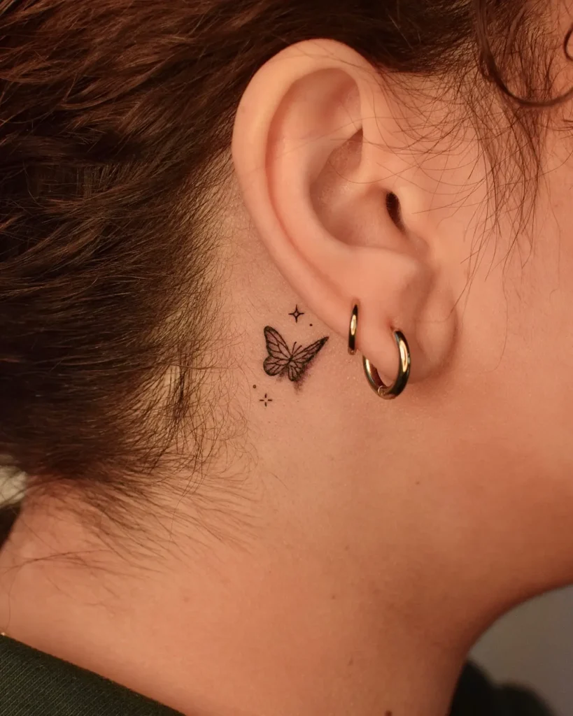 Small butterfly tattoo placed behind the ear, detailed in fine black ink with tiny sparkles. Discreet and graceful design—great for animal tattoo ideas simple and easy. Ideal for minimalist style and subtle placement seekers wanting something symbolic and lightweight.









