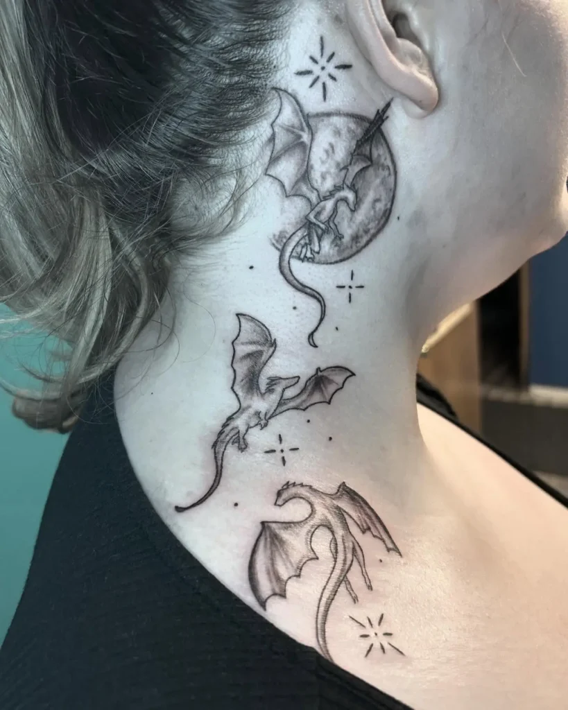 Fantasy dragon neck tattoo for women featuring three flying dragons, moon, and stars along the throat in soft black shading.