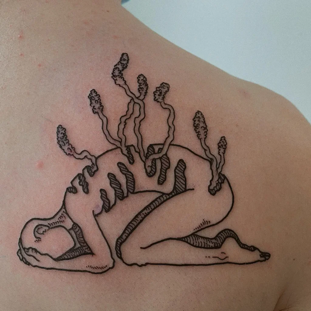 A linework tattoo of a person curled up with plants or fungi growing from their back, symbolizing growth, healing, and resilience through struggle.