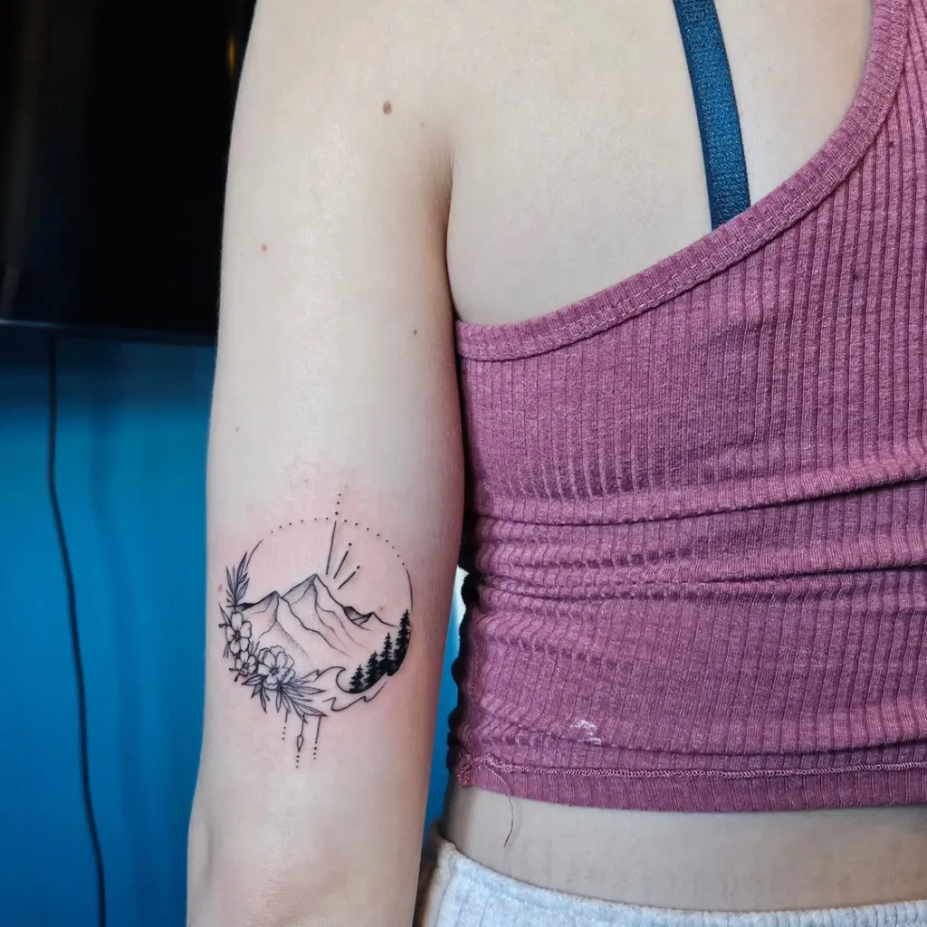 Small minimalist cherry tattoo on the inner ankle of a woman, featuring two cherries with thin black lines.