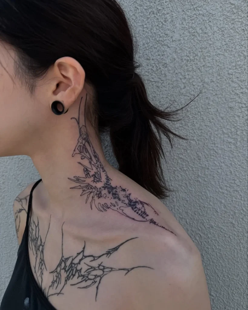 Abstract dragon-inspired neck tattoo stretching to collarbone, edgy neck tattoos for women design with jagged lines and fierce motion.