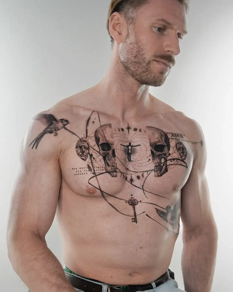 Artistic chest tattoo for men showing two skulls, human faces, birds, a silhouetted figure in the center, geometric lines, and a floating key; the design combines realism with symbolic imagery about life, death, and mystery.