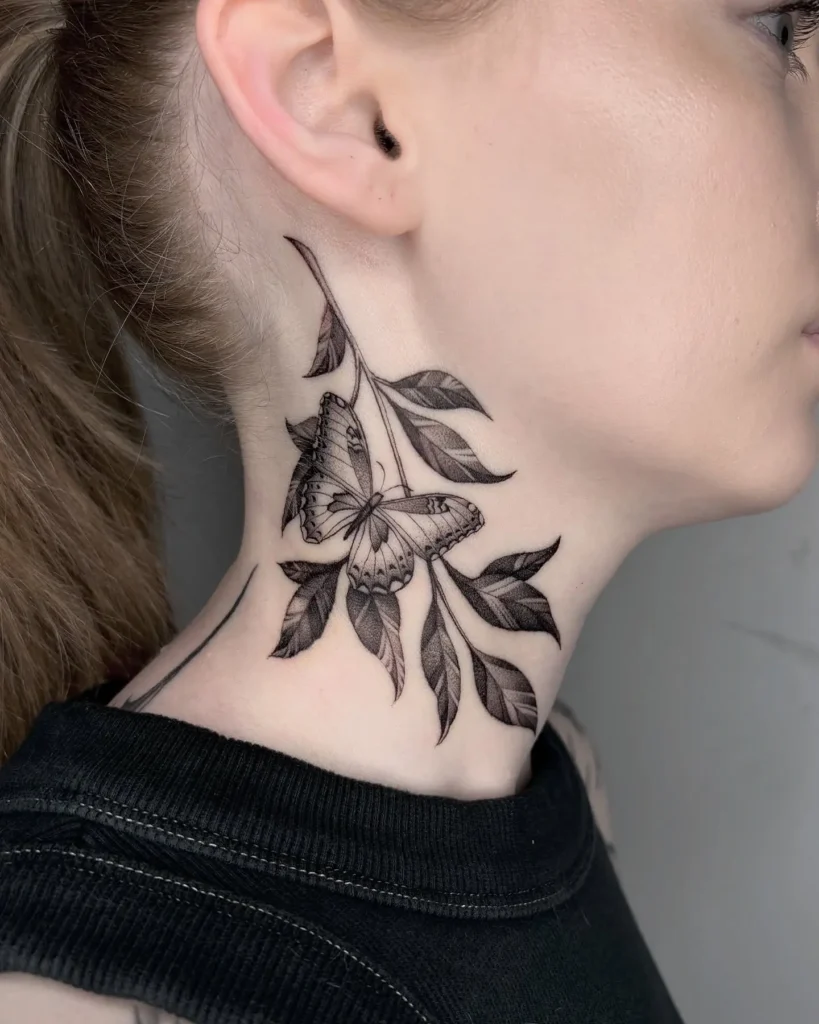 Butterfly and leaf neck tattoo for women, detailed blackwork design curving along the throat with graceful nature-inspired elements.
