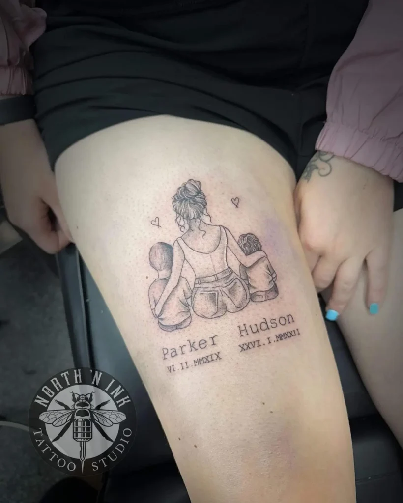 Thigh tattoo featuring a mother with two children sitting side by side, arms wrapped around each other, and small hearts above their heads. Below the trio, names “Parker” and “Hudson” appear with their birthdates in Roman numerals. The black linework highlights family unity, making it a memorable choice for mom and daughter tattoos unique and meaningful.
