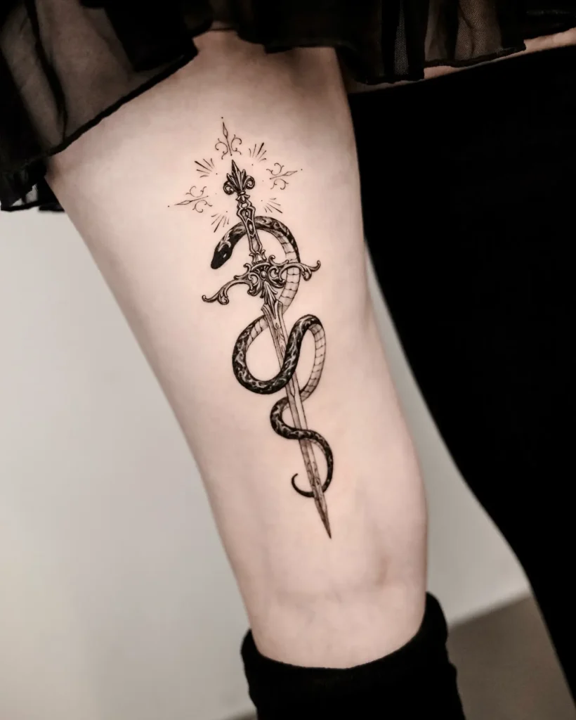 1. Serpent and Dagger Thigh Tattoo