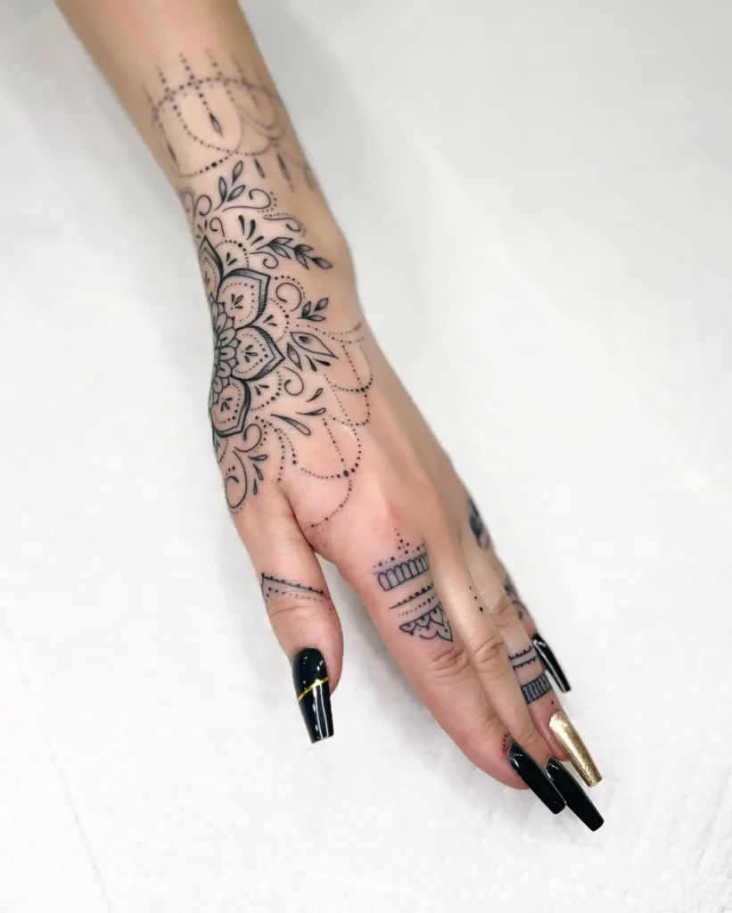11. Delicate Finger and Hand Mandala Tattoo