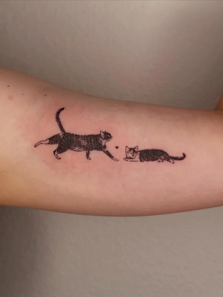 12. Curious Cats with Heart Tattoo