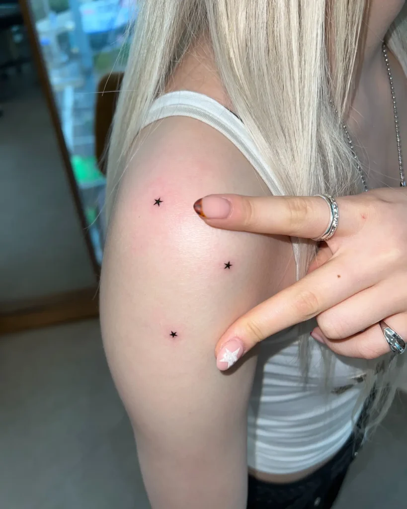 13. Four Tiny Star Tattoos on Upper Arm