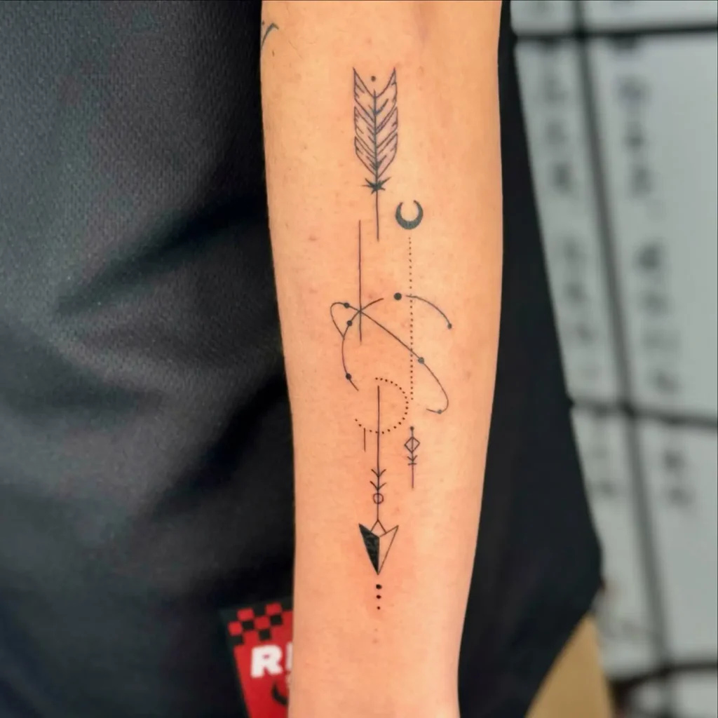 15. Geometric and Celestial Arrow Forearm Tattoo