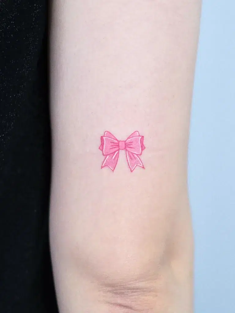 6. Pink Bow Tiny Tattoo on Arm