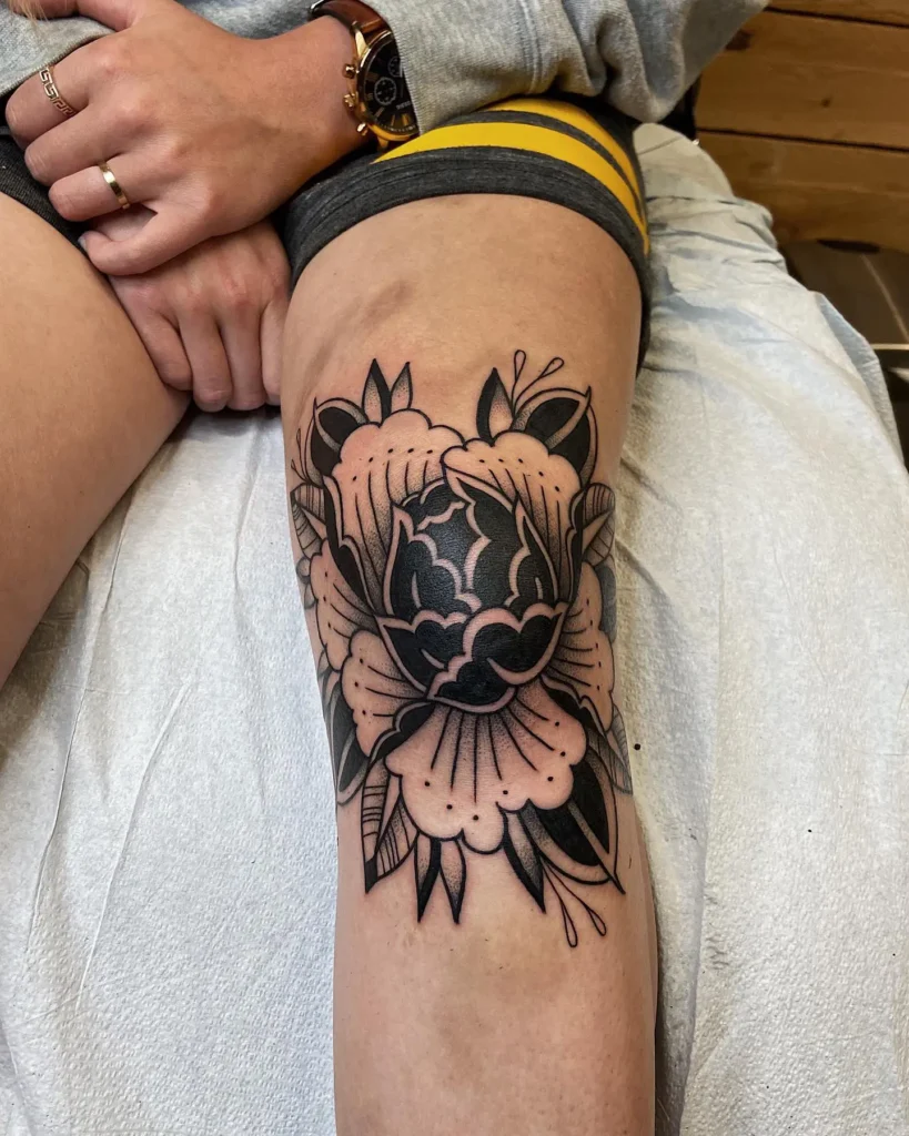 8. Bold Peony Knee Tattoo
