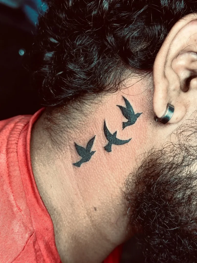 8. Flying Birds Neck Tattoo