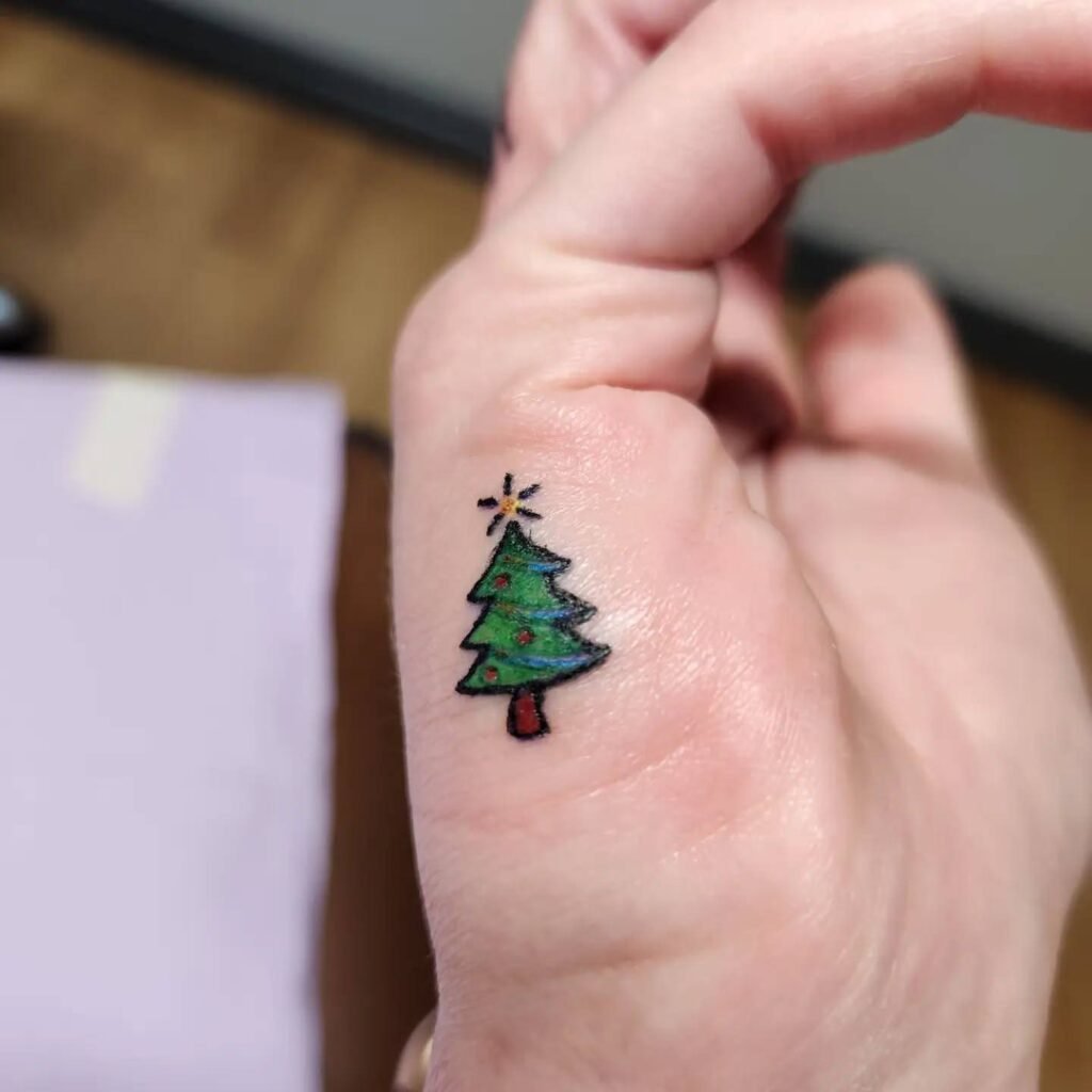11. Tiny Christmas Tree Finger Tattoo