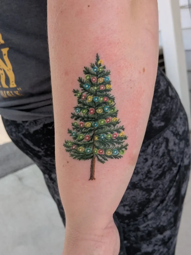 4. Classic Lit-Up Christmas Tree Tattoo
