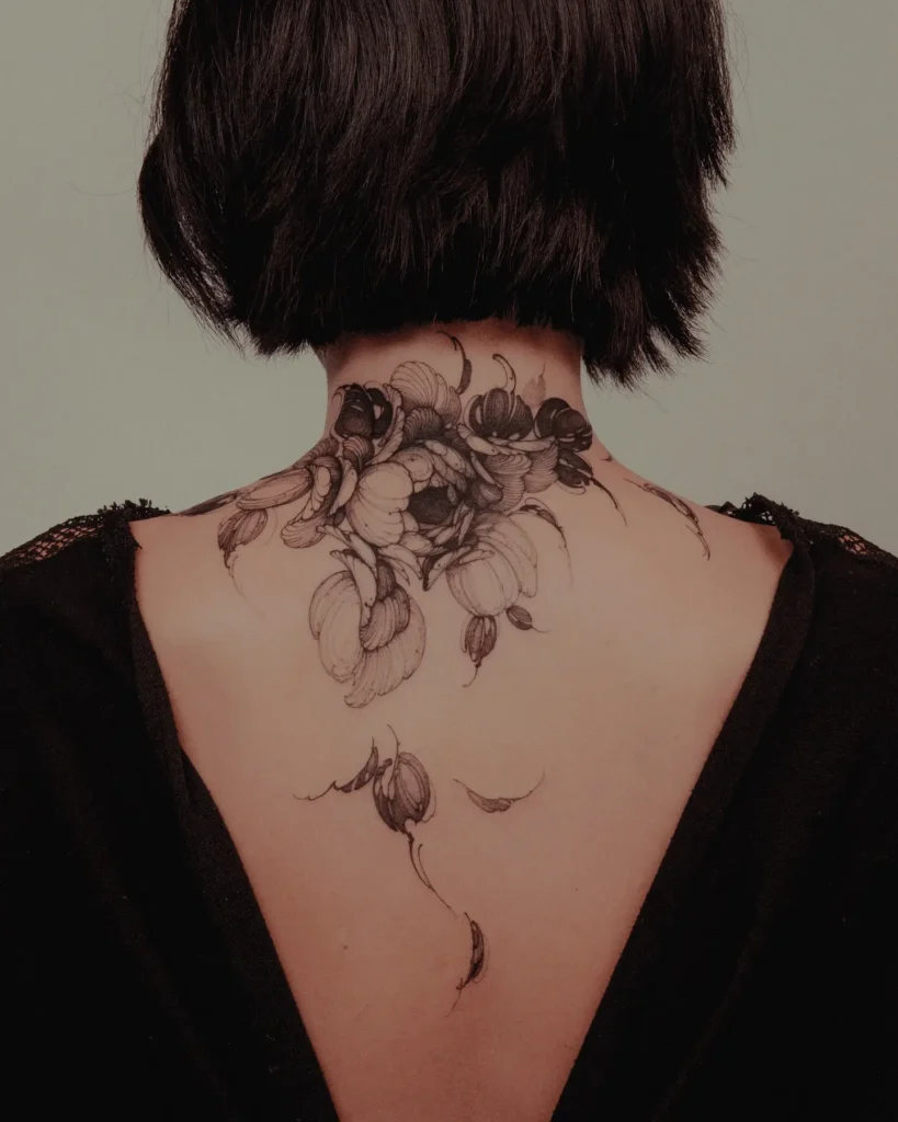 8. Delicate Neck Bloom Tattoo Cover Up