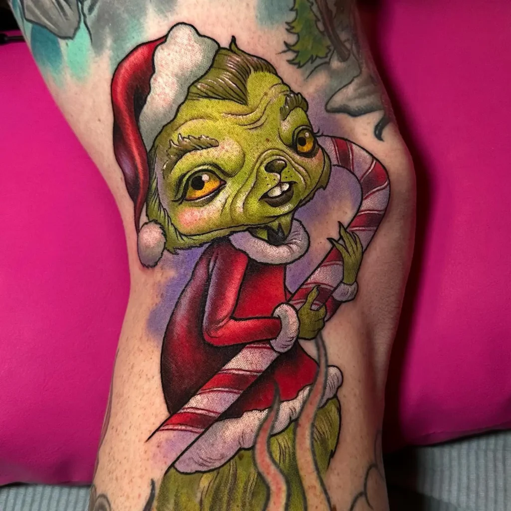 8. Grinch with Candy Cane Christmas Tattoo