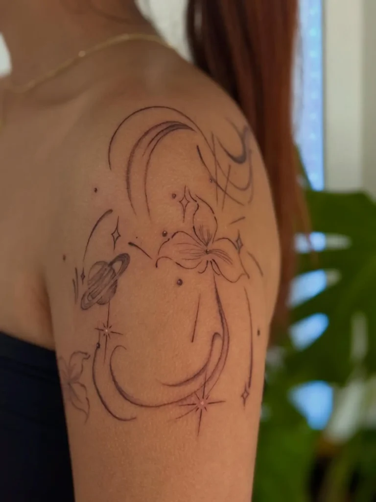 9. Cosmic Lilies – Celestial Y2K Arm Tattoo