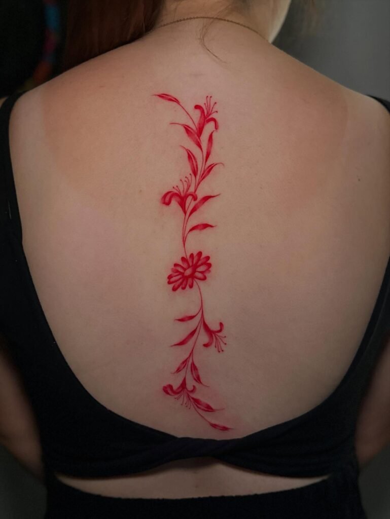 13. Vertical Red Floral Spine Tattoo