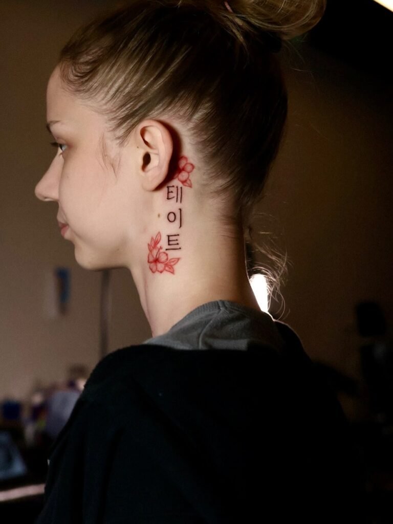 19. Red Floral Korean Script Tattoo Behind Ear