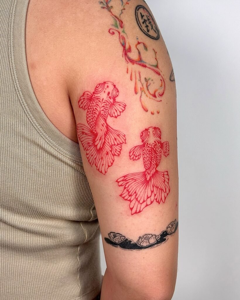 9. Twin Red Koi Fish Tattoo on Upper Arm